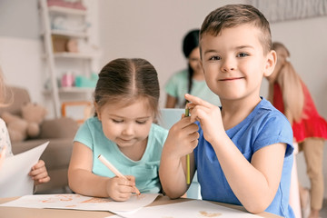 Cute little children drawing in kindergarten