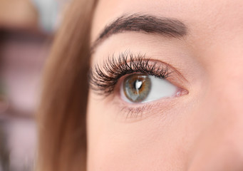 Eye of beautiful young woman with eyelash extensions, closeup
