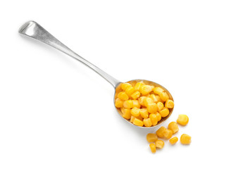 Spoon with corn kernels on white background