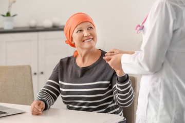 Mature woman with cancer visiting doctor in hospital