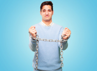 young handsome tanned man with a chain. freedom concept