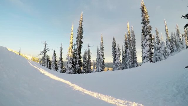 People ride snowmobile in snowy mountains, low angle