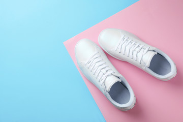 Pair of sneakers on color background, flat lay. Space for text