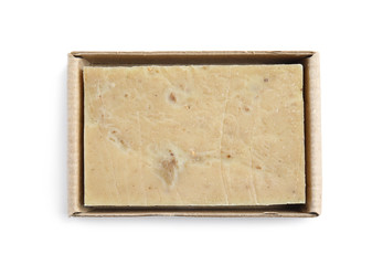 Hand made soap bar in cardboard package on white background, top view
