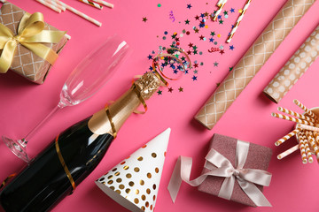 Creative flat lay composition with bottle of champagne on color background