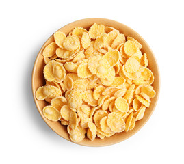 Bowl with crispy cornflakes on white background, top view