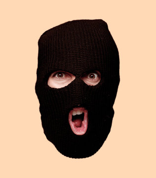 young crazy bearded man cutout head expression isolated. criminal with ski mask role. angry expression
