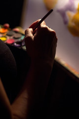 Artist with his paintings