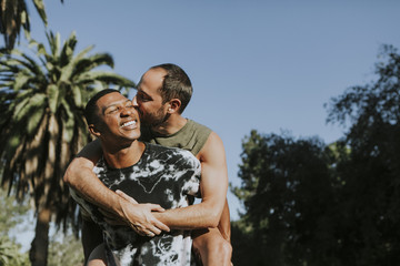 Gay couple hugging in the park