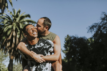 Fototapeta premium Gay couple hugging in the park