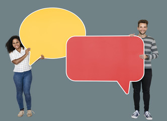Man and woman holding speech bubble icons