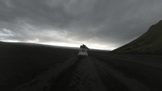 Vehicle drives on muddy Iceland landscape, POV