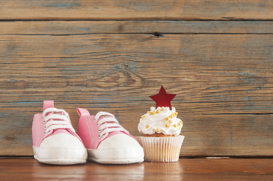 Delicious birthday сupcakes for a baby shower on wooden background