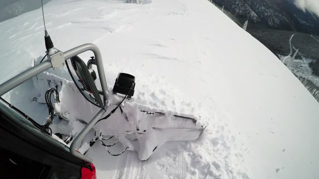 Canadian snowplow on snowy mountain, POV close up