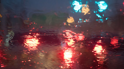 Rain and traffic jams blur background