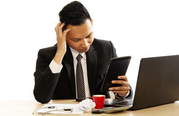 Business man looking into tablet computer and having headache on white backgrounds