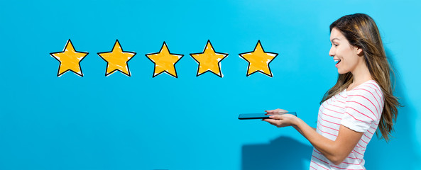 Five star rating with young woman using her tablet