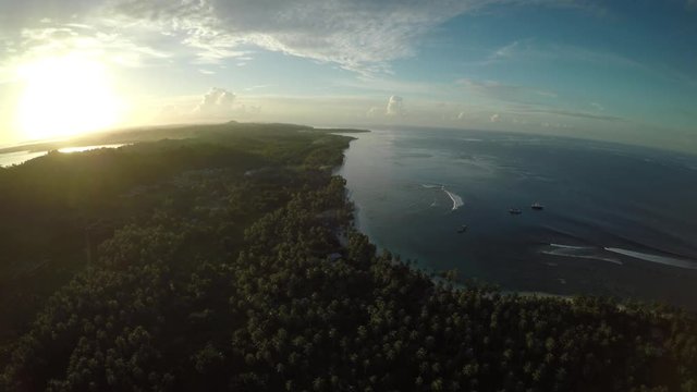 Aerial, sun sets over island landscape