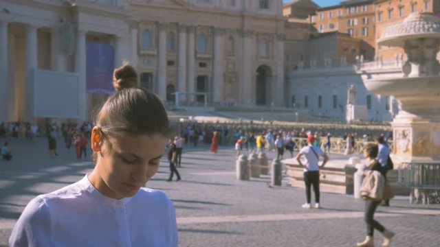 girl does a photo on the central square of the Vatican Piazza San Pietro