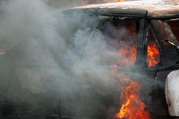 Firefighter works to extinguish car fire