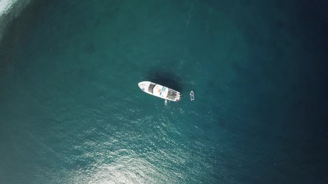 Overhead aerial, boat in tropical ocean