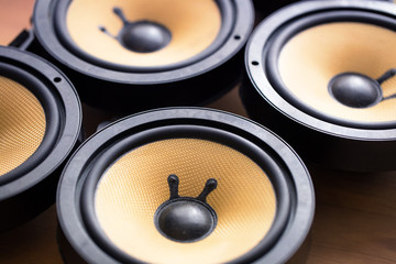 Tweaking audio. Audio speakers on a work table. Shallow depth of field.