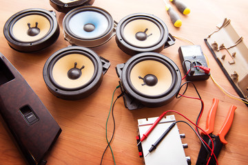 Tweaking audio. Car audio speakers on a work table. - obrazy, fototapety, plakaty