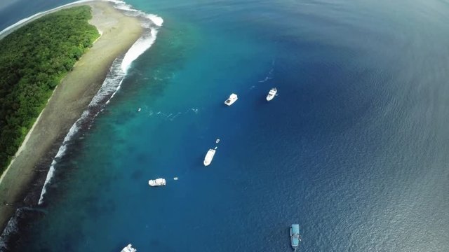 Boats off island shore, overhead aerial