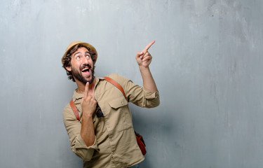 young traveler man or tourist gesturing victory, with a happy, proud and satisfied look on face,...