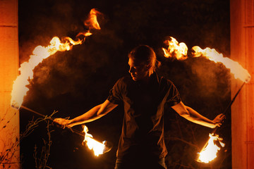 Fire show. Fakir dances with two Staff. Night performance.
