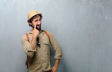young traveler man looking, observing, keeping an eye on an object in front, or watching out for...