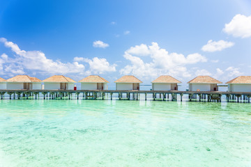 Tropical Water villas on Maldives island in the morning, holiday vacation background concept