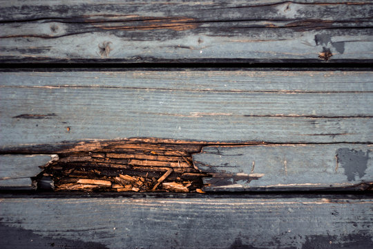 Closeup of a dark brown wooden with a splinter