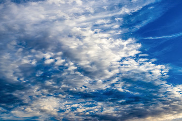 Abstract fantastic clouds at sunset on the background of a multi-colored sky