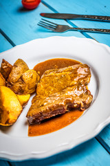 Grilled pork steak and fried potatoes