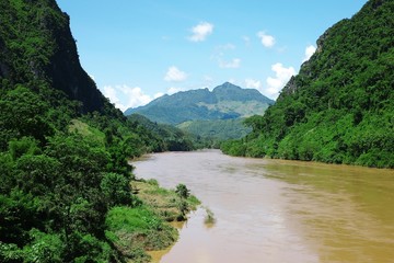 Fototapeta na wymiar tropical river with hills mountains and the lush cloud forest
