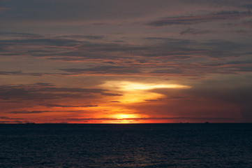 Naklejka na ściany i meble Beautiful red sunset over the ocean
