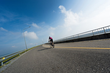 Asian man cycling road bike in the morning