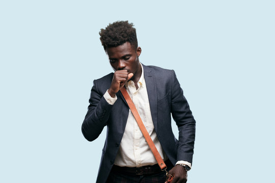 young black businessman Coughing, suffering a winter illness such as a cold or the flu, feeling unwell and feverish.