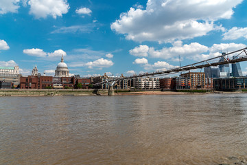 The river Thames, the Millennium Bridge and the St. Paul's Cathedral in London on a sunny day