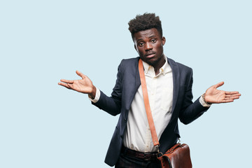 young black businessman with a quizzical and confused look, doubting between different choices or...