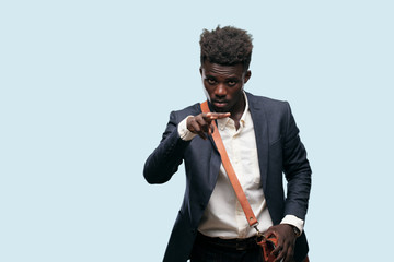 young black businessman looking, observing, keeping an eye on an object in front, or watching out...