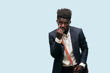 young black businessman looking, observing, keeping an eye on an object in front, or watching out...