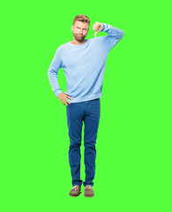 young blonde man with a dissenting, serious, stern expression, with thumbs down in disapproval.