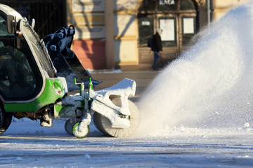 street cleaning the city from snow with the help of special machinery