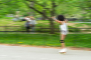 NEW YORK, USA - MAY 5, 2018: Unidentified people riding skateboard in Central Park