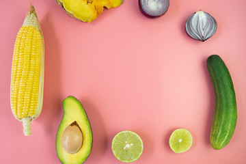 Top view of fresh vegetables on pink background.