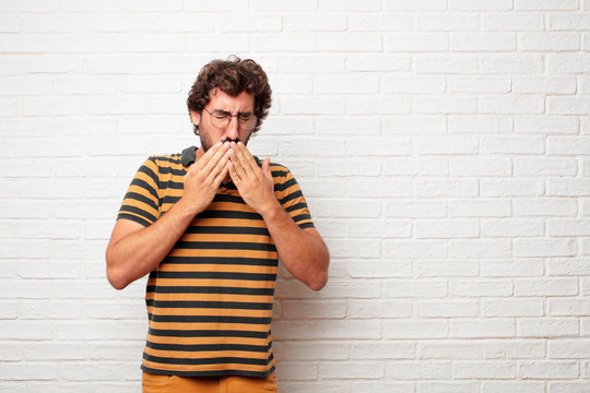 young dumb man Coughing, suffering a winter illness such as a cold or the flu, feeling unwell and feverish.
