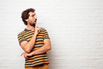 young dumb man with a goofy, dumb, silly look, feeling shocked and confused at a recent realization, not really understanding an idea.