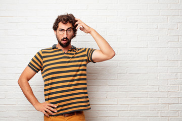 young dumb man with a goofy, dumb, silly look, feeling shocked and confused at a recent realization, not really understanding an idea.